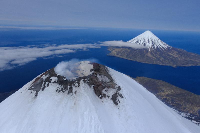 The summit of Cleveland Volcano on June 1, 2023, showing steaming and degassing at the summit crater. Carlisle Volcano is visible in the background.