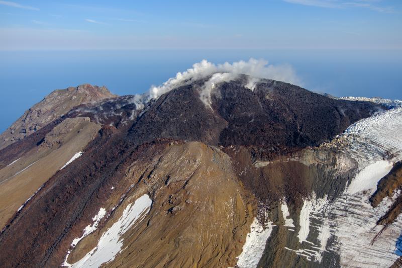 Oblique view of Great Sitkin Volcano looking northeast the active lava flows from the crater taken on September 1, 2023 during a helicopter overflight by AVO geologists. 