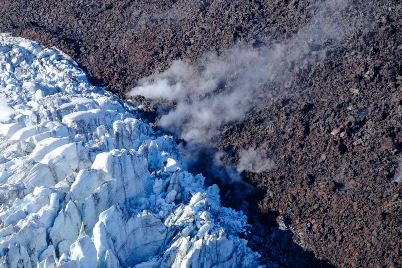 Lava-ice contact oblique view of the active east lobe of lava in the summit crater of Great Sitkin Volcano. Photo taken on September 1, 2023 during a helicopter overflight by AVO geologists.