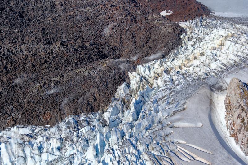 Lava-ice contact oblique view of the active east lobe of lava in the summit crater of Great Sitkin Volcano. Photo taken on September 1, 2023 during a helicopter overflight by AVO geologists.