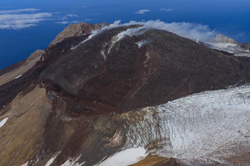 Oblique view of Great Sitkin Volcano looking north at the active lava flows in the crater. Photo taken on September 1, 2023 during a helicopter overflight by AVO geologists. 