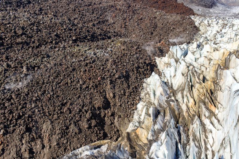 Lava-ice contact oblique view of the active east lobe of lava in the summit crater of Great Sitkin Volcano. Photo taken on September 1, 2023 during a helicopter overflight by AVO geologists.