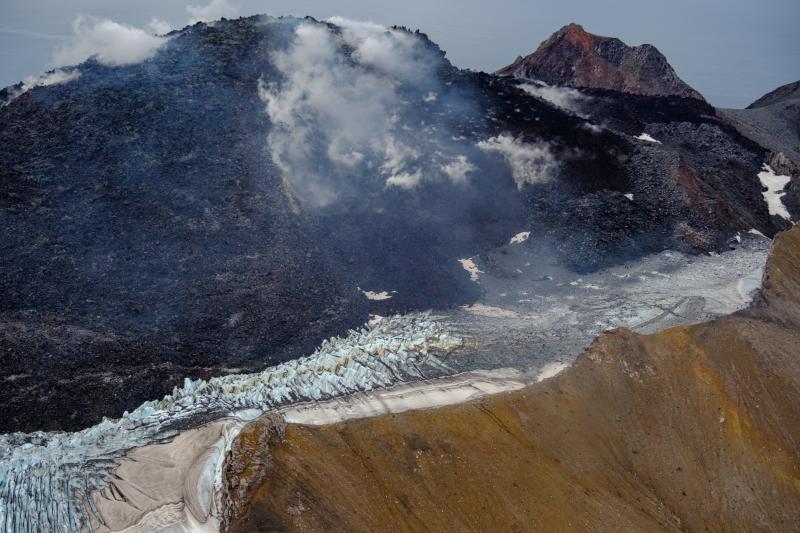 Great Sitkin Volcano on September 3, 2023, during helicopter approach for sampling efforts by AVO geologists. Image is looking west at the east margin of the summit flow field.