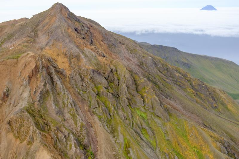 North face of Mount Moffett looking west with the peak of Kanaga in the background (upper right).