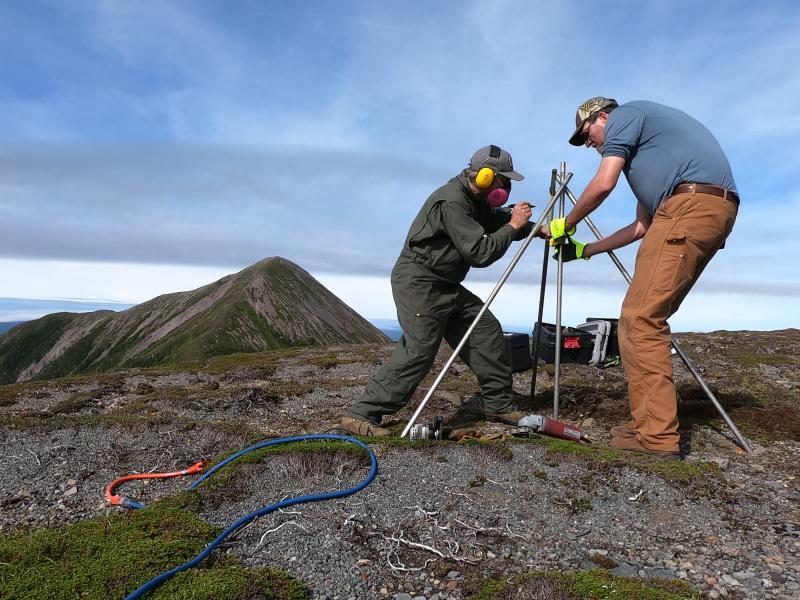 Installation of AVO&#039;s new seismic and GNSS network at Mt. Edgecumbe volcano, August 20-29 2023.  AVO field technician Max Kaufman and UAF Geodesy professor Ronni Grapenthin construct GNSS antenna monument at site EDCR on Crater Ridge. 12 ft long by 1&quot; stainless steel rods are driven 7 ft into the ground, and welded together at the top.