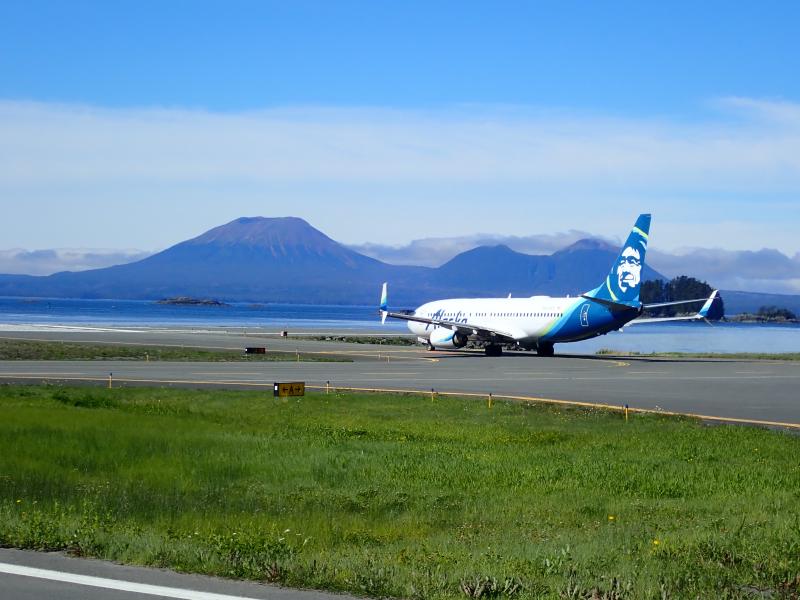 Alaska Airlines 737 taxi for take-off with Mt Edgecumbe in the background.