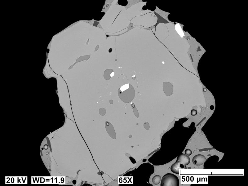 Backscatter electron images (BSE) of polished sections of tephra erupted from Shishaldin in 2023 and collected near AVO station ISNN northeast of the volcano. Sample has a vesicular, glassy matrix with plagioclase (dark gray) and olivine (light gray). Mineral in the center is an olivine with rounded melt inclusions.