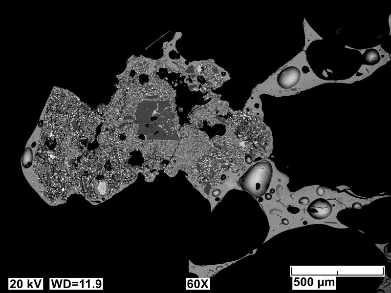 Backscatter electron images (BSE) of polished sections of tephra collected on the south coast of Unimak Island and probably erupted from the 2023 Shishaldin eruption. Image shows a crystallized fine-grained plagioclase and oxide inclusion hosted in a vesicular and glassy host tephra.