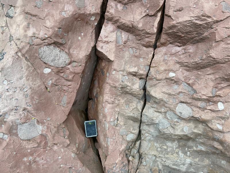 Abundant enclaves exposed in rock face on north shore of Adagdak volcano (just beyond the former Loren station). 20 cm long tablet for scale.