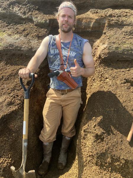 USGS/AVO geologist Jordan Lubbers working on exposing a tephra section on Unimak Island. Jordan is standing in a 1 meter thick deposit of pumice that is probably from the Fisher caldera forming eruption. 