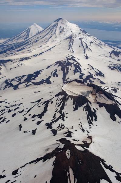 Photo of Pavlof Volcano (top center), Pavlof Sister (top left), and Mount Hague (crater in center) during an overflight on July 23, 2024.