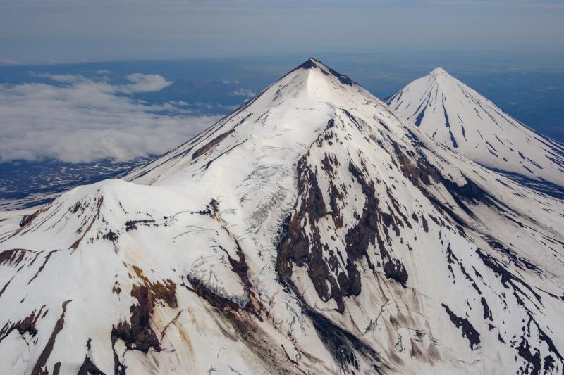 From right to left: Pavlof Sister, Pavlof, and Little Pavlof volcanoes viewed during an overflight on July 23, 2024.