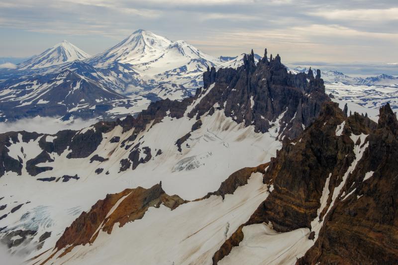 The Aghileen Pinnacles on the north side of Emmons Caldera with Pavlof and Pavlof Sister in the background.