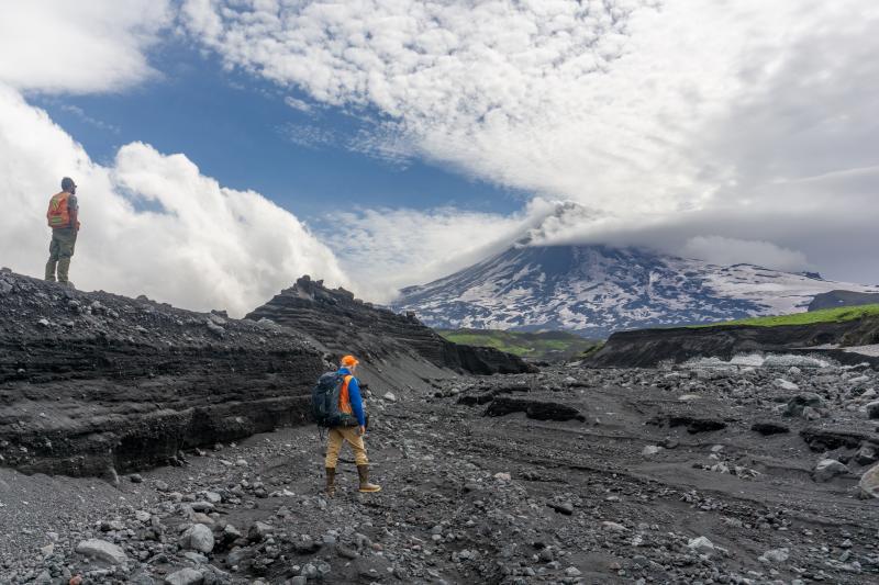 AVO Geologists M. Loewen (left) and C. Waythomas (right) on the north side of Shishaldin discussing lahar flow paths from the 2023 eruption. Shishaldin is in the background.