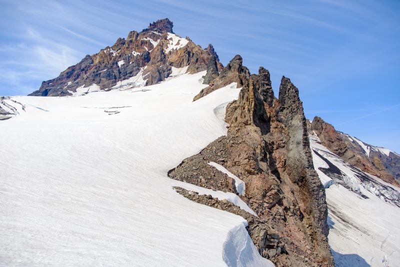 Vertical dike radiating outward from the summit of Isanotski Peaks, following a ridge on the east-southeast flank.