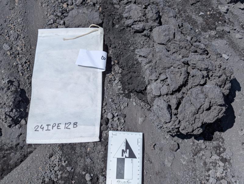 Volcanic bomb from the 2023 Shishaldin eruption, event #12 pyroclastic flow, with friable structure and vesicular core (24IPE12B).