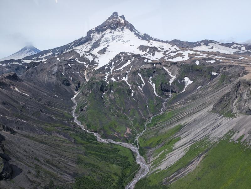 View of Isanotski Volcano on July 30, 2024, during AVO fieldwork on Unimak Island. Shishaldin Volcano is visible in the background on the left.