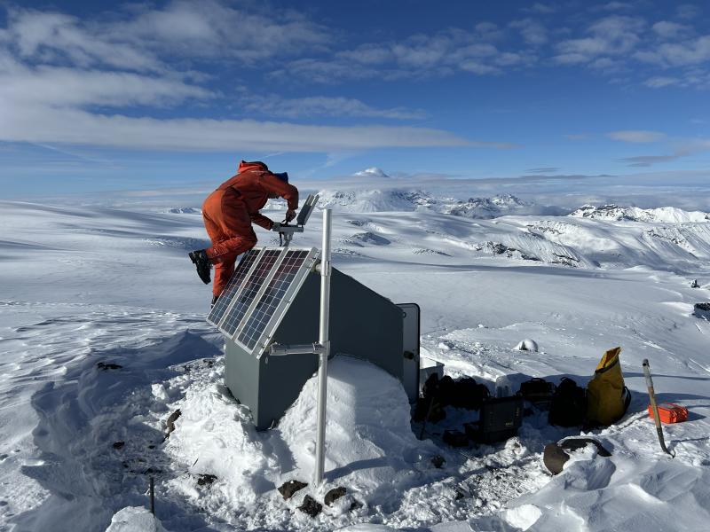 Max Kaufman working on a camera at seismic station WAZA. Mount Drum in the background. 