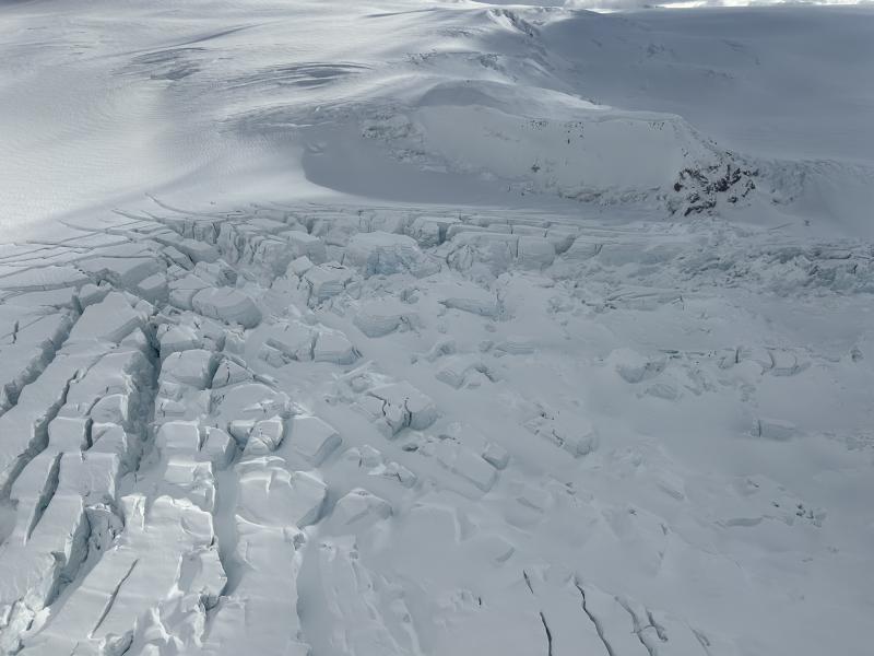 Across a field of seracs, seismic station WAZA sits atop a knoll at the top of the frame.