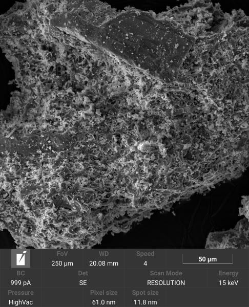 Closeup scanning electron microscope image of an individual ash grain collected in Anchorage after the August 1992 Crater Peak eruption from Mount Spurr. This grain is from a bulk sample that was not cleaned or sieved and has small particles on the larger grain surface.