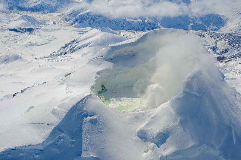 Mount Spurr summit and crater lake with Crater Peak just visible behind the summit cone. Photo from an April 25 overflight and gas survey. View is looking south. 