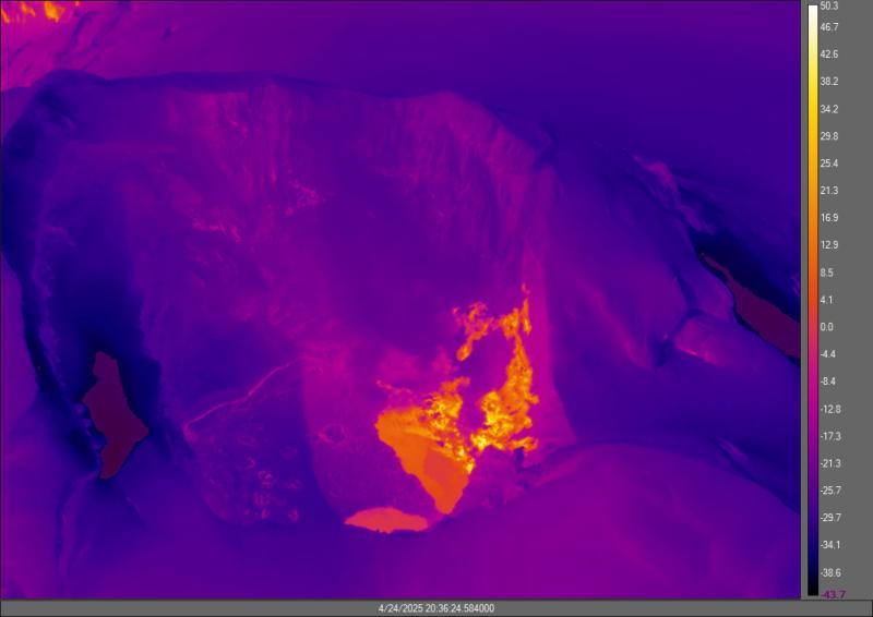 Representative thermal image of the Spurr summit crater lake and fumaroles, captured by a FLIR (forward-looking infrared) camera. The colors show approximate temperature in degrees Celsius (see scale bar on right hand side of the image). The warmest part of the lake is ~8&deg;C (orange), but most of the lake remains covered in snow and ice (purple). The fumaroles are hotter (yellow and white) and are producing the the hazy steam and gas plume (visible in pink and purple).
