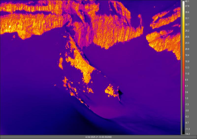Representative thermal image of the Crater Peak fumarole area captured by a FLIR (forward-looking infrared) camera. The colors show approximate temperature in degrees Celsius (scale on the right hand side). The snow-free ridge that hosts the fumaroles is in the center of the image and is approximately the same temperature as the crater walls above it. The areas of bare rock are warmer than the areas of snow and ice (black to purple in this image) due to heating from the sun.