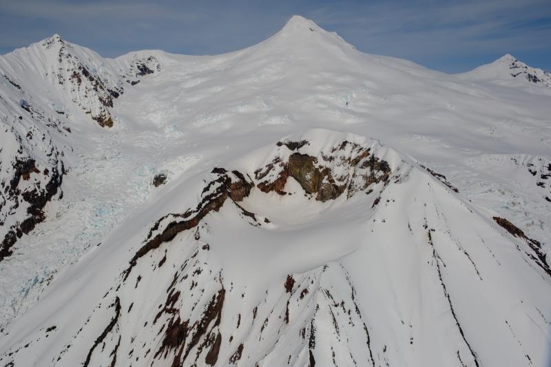 Crater Peak (front) and the Mount Spurr summit (center horizon) during a gas and photo survey overflight on May 23, 2025.
