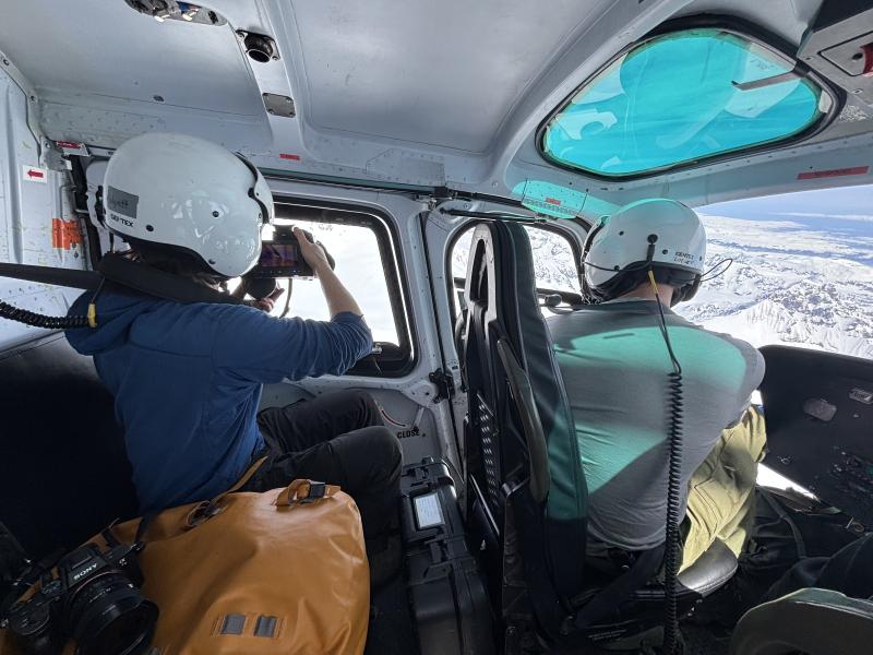 Alaska Volcano Observatory staff capture thermal and regular oblique air photos from a helicopter during an overflight of Mount Spurr summit on May 23, 2025.