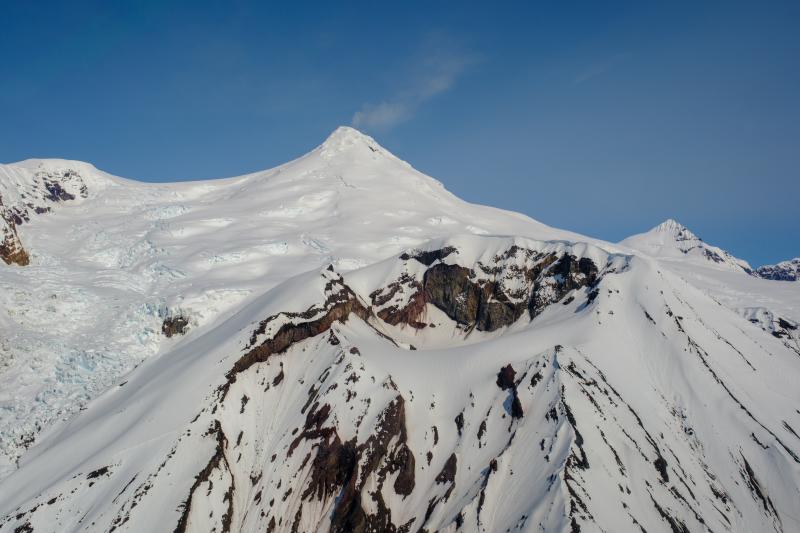 Crater Peak (center right) and Mount Spurr (center horizon) during an overflight  photo and gas survey of Spurr volcano on June 11, 2025. The summit gas plume was visible drifting south. 