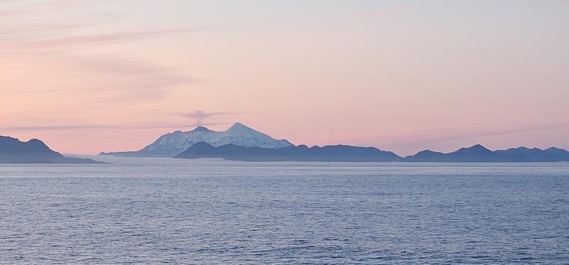 View of Great Sitkin Volcano from the R/V Atlantis. Note the relief of the lava dome and a small vapor plume rising above the dome. View is to the east.