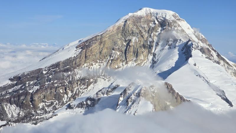 Iliamna Volcano, viewed from the south. The active fumarole regions on the eastern flank are visibly steaming.