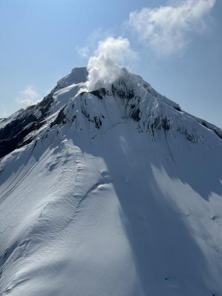 The east face of Iliamna Volcano, displaying a typical level of steaming from a persistent fumarole field along its eastern ridge.