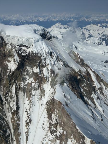 A fumarole field on the eastern ridge of Iliamna Volcano displaying a typical level of steaming, as seen from an overflight on July 8th, 2025, en route to seismic station IVE, one of six local geophysical monitoring stations.