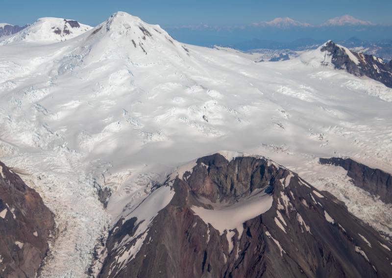 Mount Spurr with the Crater Peak flank vent in the foreground and the Alaska Range visible in the background. This oblique aerial photograph was captured during an observation and gas measurement overflight on August 17, 2025. 