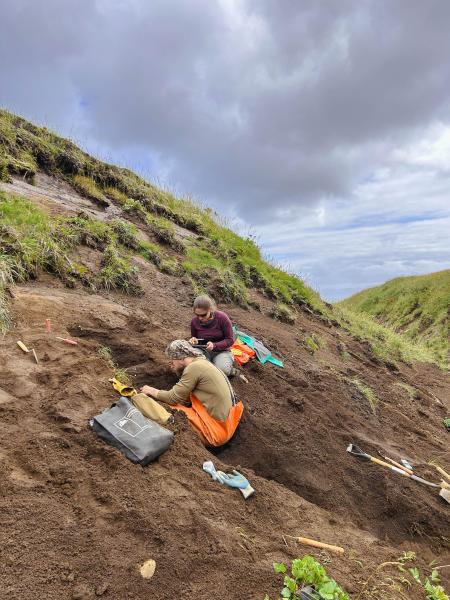 AVO geologists Hannah Dietterich and Jordan Lubbers work at tephra site 25AASHD003, on the south flank of Sarichef Peak. Photo taken during field work at Atka volcanic complex, northern Atka Island. 