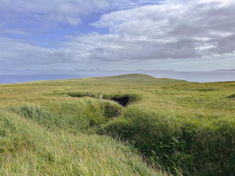 AVO geologists Hannah Dietterich and Jordan Lubbers at tephra site 25AASHD011, near the southern coast of northern Atka Island. Photo taken during field work at Atka volcanic complex, northern Atka Island. 