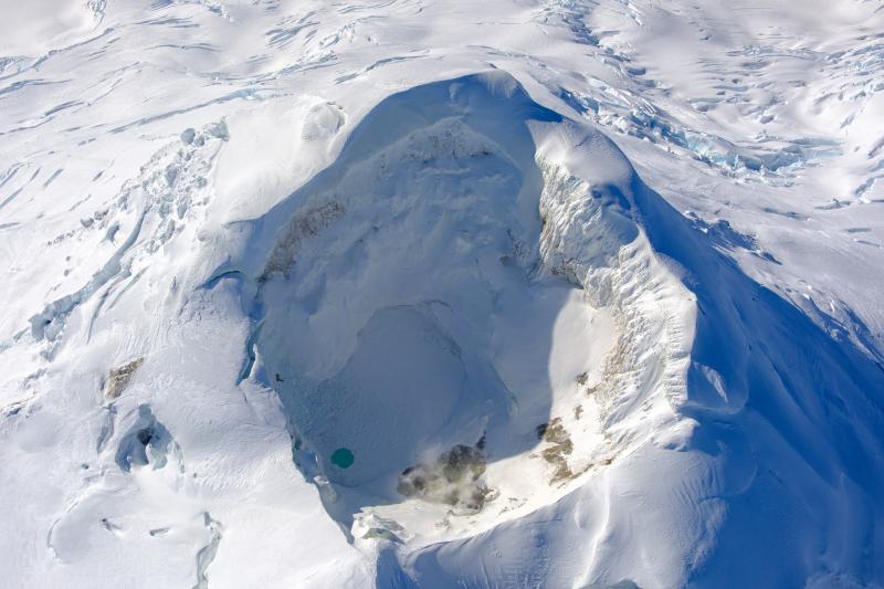Mount Spurr summit during a gas and geology fieldwork on September 30, 2025. View is looking south. The crater lake is nearly frozen over, and fumarole area on the north side of the lake still lightly steaming. 