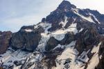 The north face of Isanotski Peaks. The upper summit is composed of thin lava flows slopping away from the volcano. These transition to massive, presumably ice-marginal lavas. A dike on the right side of the image can be seen cutting both lower and upper lava flows and radiating outward from the summit.