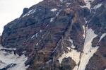 The north face of Isanotski Peaks focused on thin lava flows that make up the uppermost edifice and are slopping away from the volcano&#039;s summit. A dike can be seen cutting these lava flows from the bottom center to the upper right of the image.