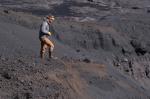 AVO geologist Jordan Lubbers standing on proximal pyroclastic flow deposits on the northeast flank of Shishaldin during geologic observation and sampling work on July 30, 2024.