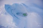 Summit and summit crater of Mount Spurr with a partially ice-covered crater lake on December 18, 2024. Photo taken part of a photo and gas survey following recent seismic unrest at the volcano.