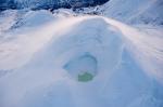 Summit crater of Mount Spurr with a partially ice-covered crater lake on December 18, 2024. Crater Peak, the source of the 1992 eruption, is just visible in the upper-left fo the image. Photo taken part of a photo and gas survey following recent seismic unrest at the volcano.