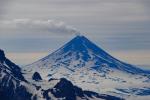 Shishaldin Volcano viewed from the summit of Roundtop Mountain on August 22, 2025. A steam and gas plume is visible drifting to the south in the image.
