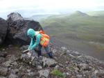 USGS geologist Hannah Dietterich collecting a Pleistocene lava sample from the south flank of Kliuchef volcano. Photo taken during field work at Atka volcanic complex, northern Atka Island. 