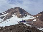 Helicopter sitting on island of lava in Kliuchef&#039;s summit icefield, near station 25AAHD008. West Kliuchef lies beyond. Photo taken during field work at Atka volcanic complex, northern Atka Island. 