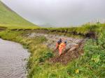 AVO geologists Hannah Dietterich and Jordan Lubbers work at tephra site 25AASHD010, west of Kliuchef volcano. Photo taken during field work at Atka volcanic complex, northern Atka Island. 