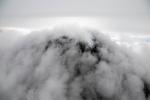 The active lava dome (black mound) at Great Sitkin is seen steaming (bright white steam) amidst ground-hugging clouds during an Alaska Volcano Observatory overflight on September 2, 2025