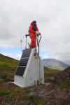 People/Personnel from AVO geophysical fieldwork in the vicinity of Dutch Harbor,  September 2025. AVO field technician Wyatt M at station CLNE, on the slopes of Cleveland Volcano. This station monitors gas emissions from the volcano with a scanning spectrometer and IR/visible cameras.