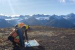 AVO Geologists M. Loewen and M. Coombs discussing Mount Spurr geology using a geologic map of the area. 